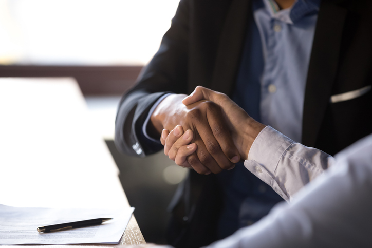 Close up african american businessman shaking hands with caucasian client. Handshake is symbol of starting finishing negotiations, successful teamwork signing contract, hiring human resource concept (Close up african american businessman shaking hands