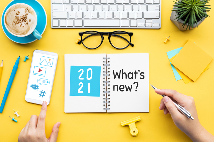 2021 What's new ? or trendy concepts with young person writing text on notepaper and office accessories.Business management,Inspiration concepts ideas (2021 What's new ? or trendy concepts with young person writing text on notepaper and office accesso